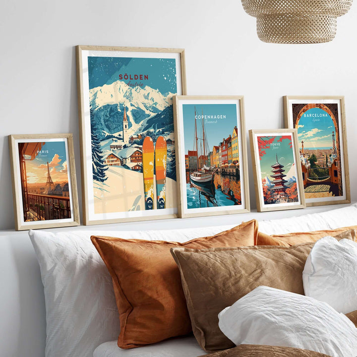 Framed Sölden ski print among travel-themed artwork on a cozy sofa, showcasing iconic destinations and ski culture.