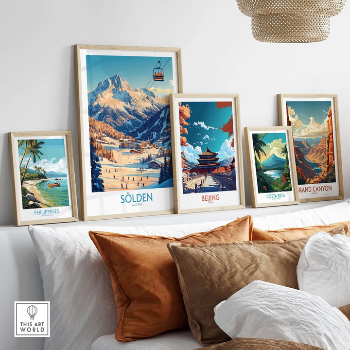 A stylish living room display featuring framed travel posters, including Sölden, Beijing, Philippines, Costa Rica, and the Grand Canyon.