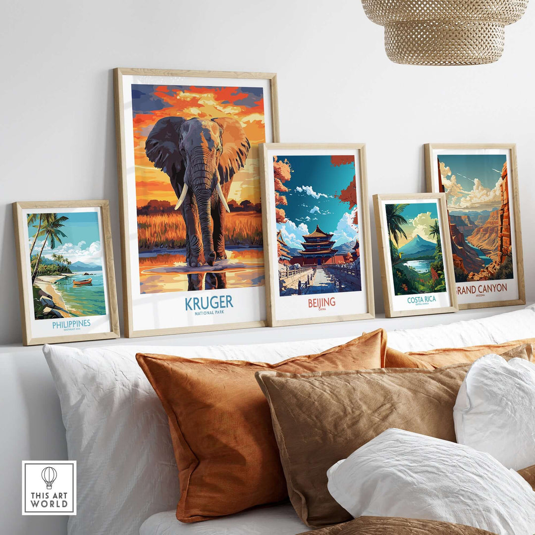 Gallery wall featuring travel posters including Kruger Park elephant art and landscapes from Philippines, Beijing and Costa Rica.