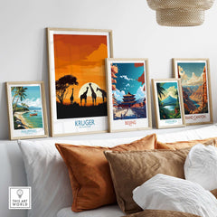 South Africa Giraffe Poster - Kruger Park Sunset, African Safari Art displayed among travel posters on a stylish wall.