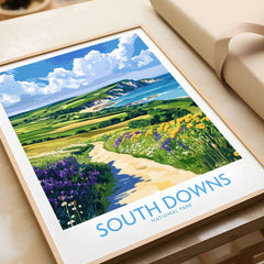 South Downs National Park Poster England featuring a scenic coastal view with flowers and hills in vibrant colors.
