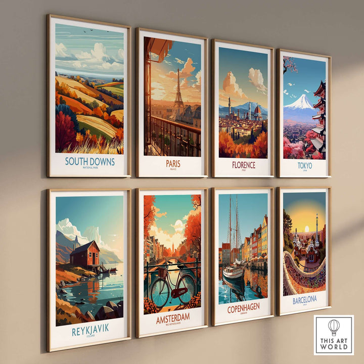 Colorful travel prints of South Downs, Paris, Florence, Tokyo, Reykjavik, Amsterdam, Copenhagen, and Barcelona on a gallery wall.