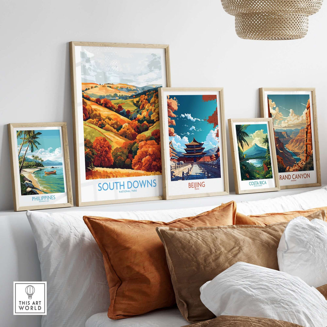 South Downs travel poster among framed artworks featuring scenic landscapes from various destinations.