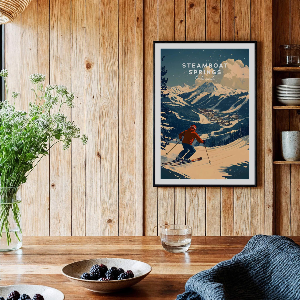 Steamboat Springs Ski Poster featuring a skier against a mountain backdrop in a cozy interior setting.