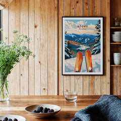 Ski Poster Stowe Vermont displayed in a cozy wooden interior with skis and a scenic mountain backdrop.
