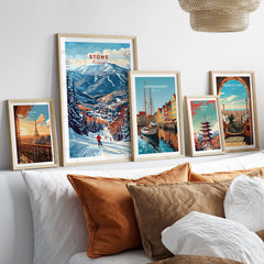 Stowe Mountain Range poster displayed among other travel art prints on a cozy bed decor, showcasing alpine scenery and cityscapes.