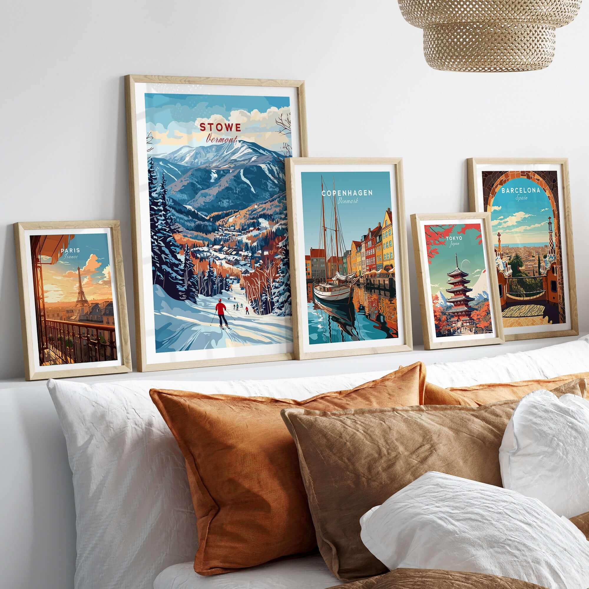 Stowe Mountain Range poster displayed among other travel art prints on a cozy bed decor, showcasing alpine scenery and cityscapes.