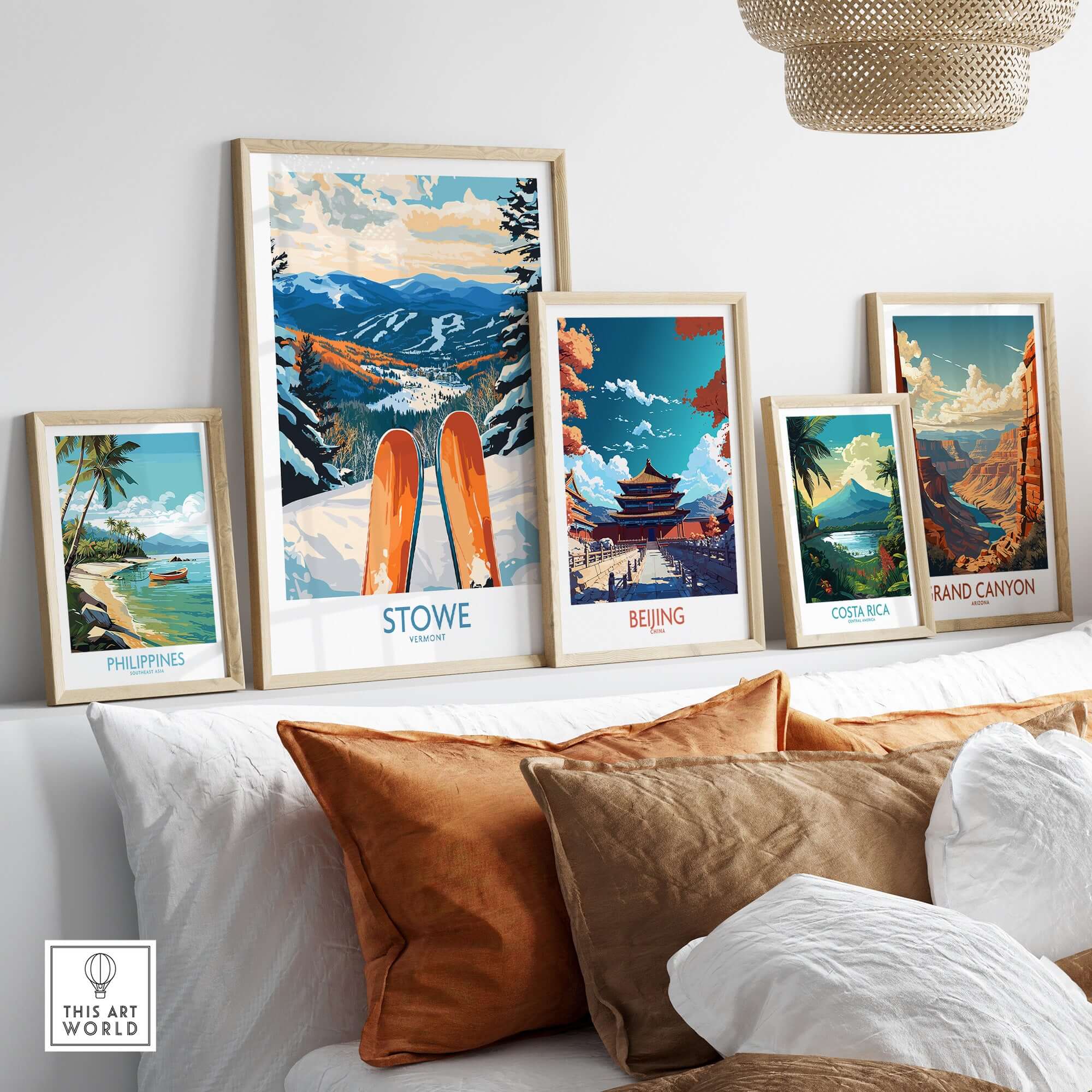 Assorted travel posters featuring Stowe, Beijing, Costa Rica, Rand Canyon, and the Philippines displayed on a couch.