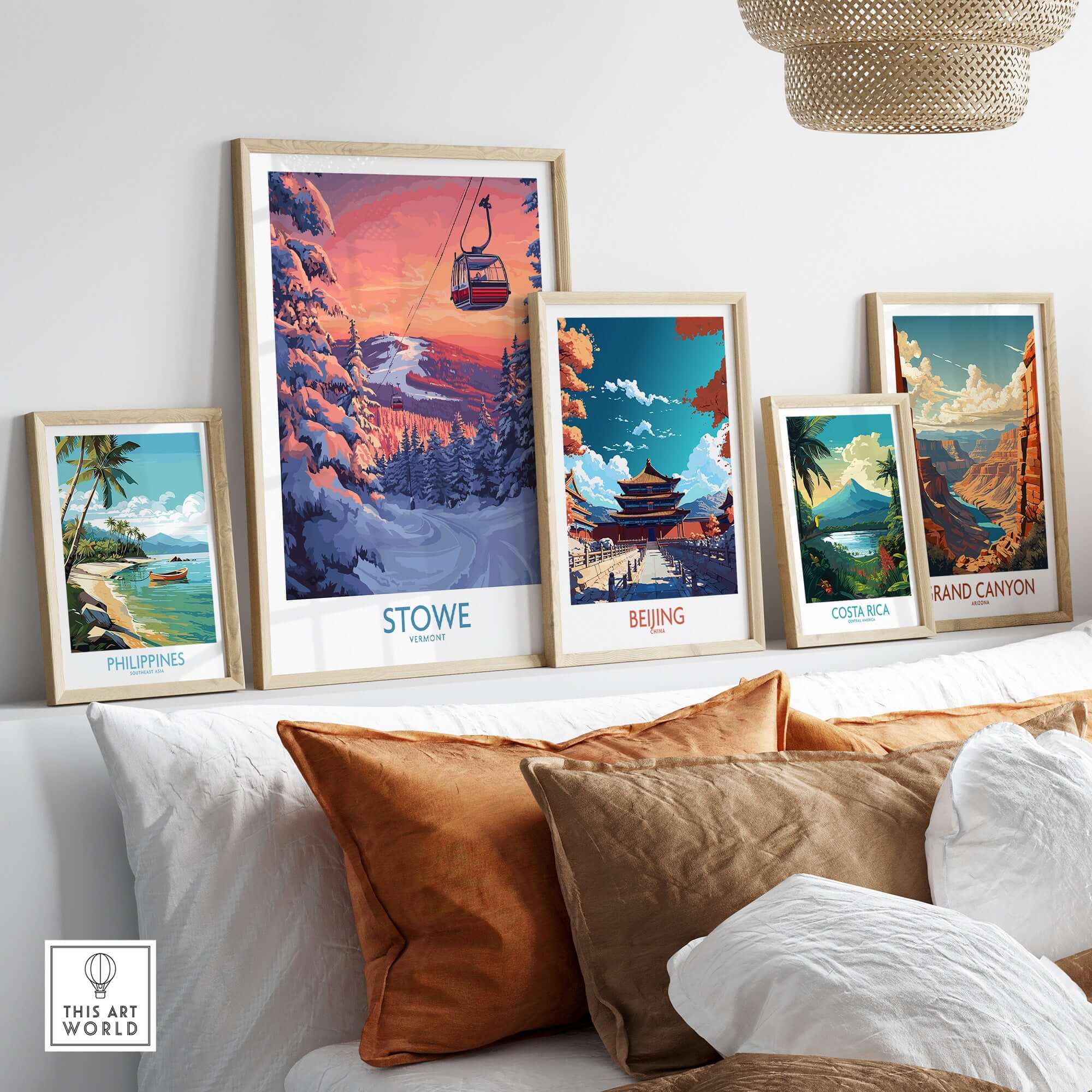 Framed art prints featuring Stowe Vermont ski poster among landscapes of Philippines, Beijing, Costa Rica, and Grand Canyon.
