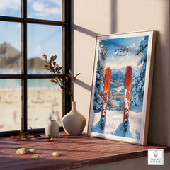 Framed Stowe Vermont ski print on a windowsill showcasing snowy mountains and ski gear, perfect for skiing decor.