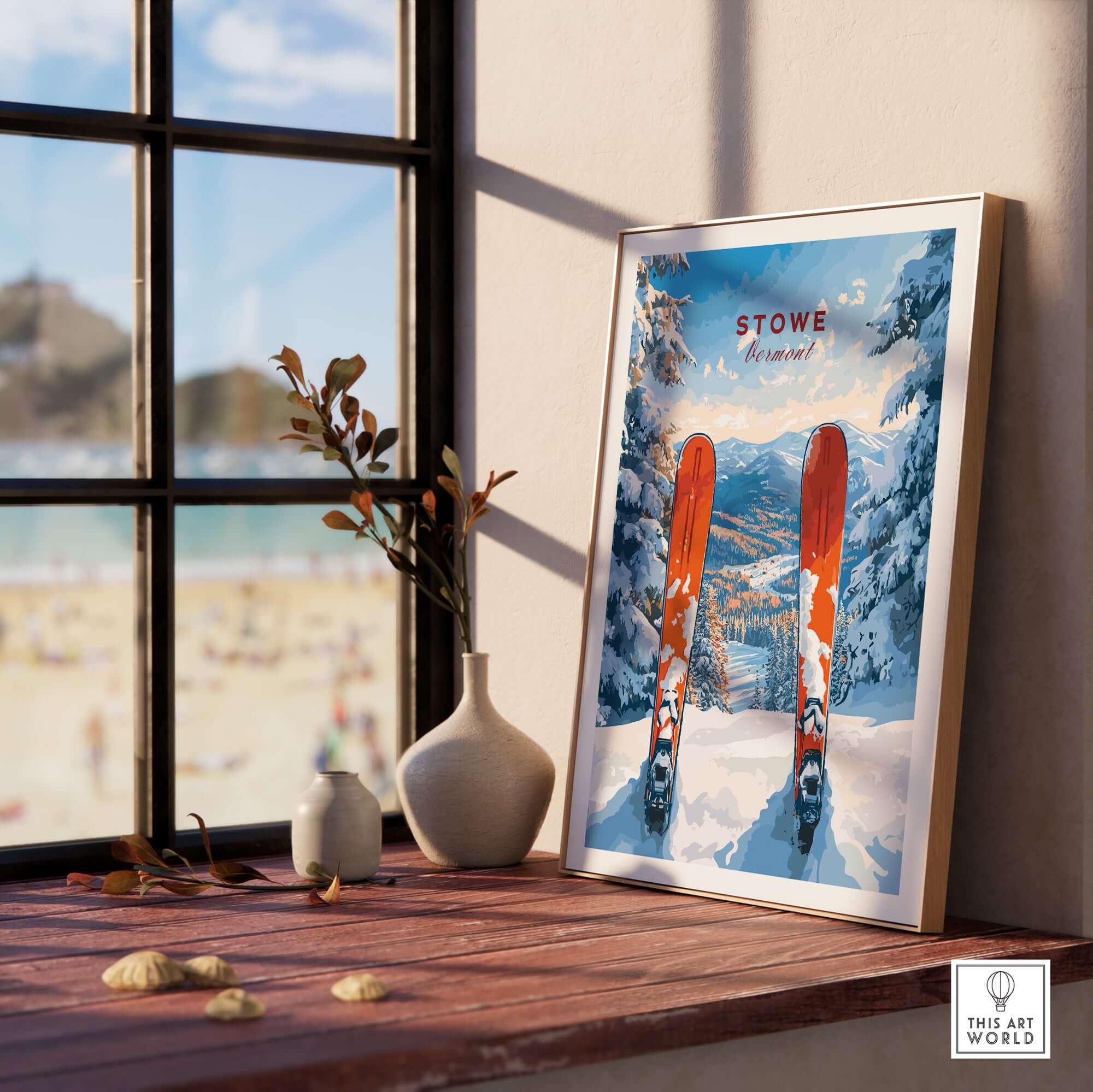 Framed Stowe Vermont ski print on a windowsill showcasing snowy mountains and ski gear, perfect for skiing decor.