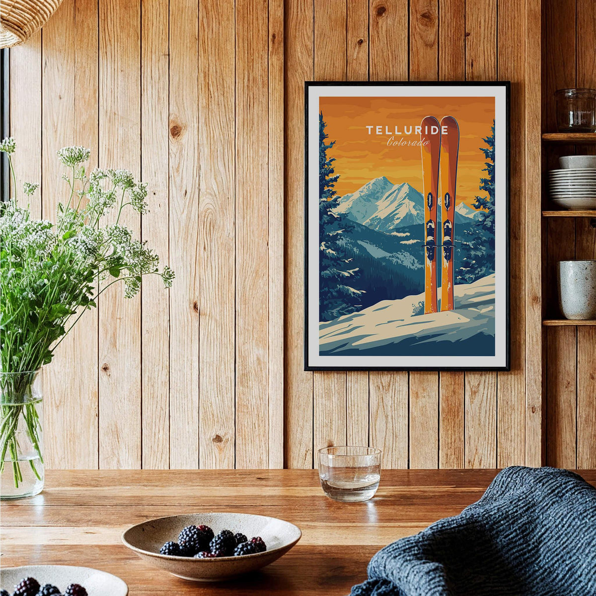 Telluride Travel Poster - Colorado framed on wooden wall, showcasing vibrant ski print with mountain backdrop.