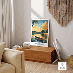 The Broads National Park Art Print displayed on a wooden surface in a serene home interior setting.