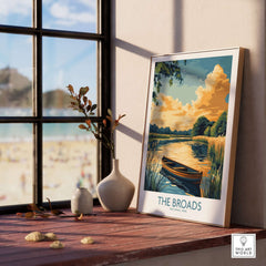 The Broads National Park Art Print displayed on a wooden table near a window, capturing the serene landscape.