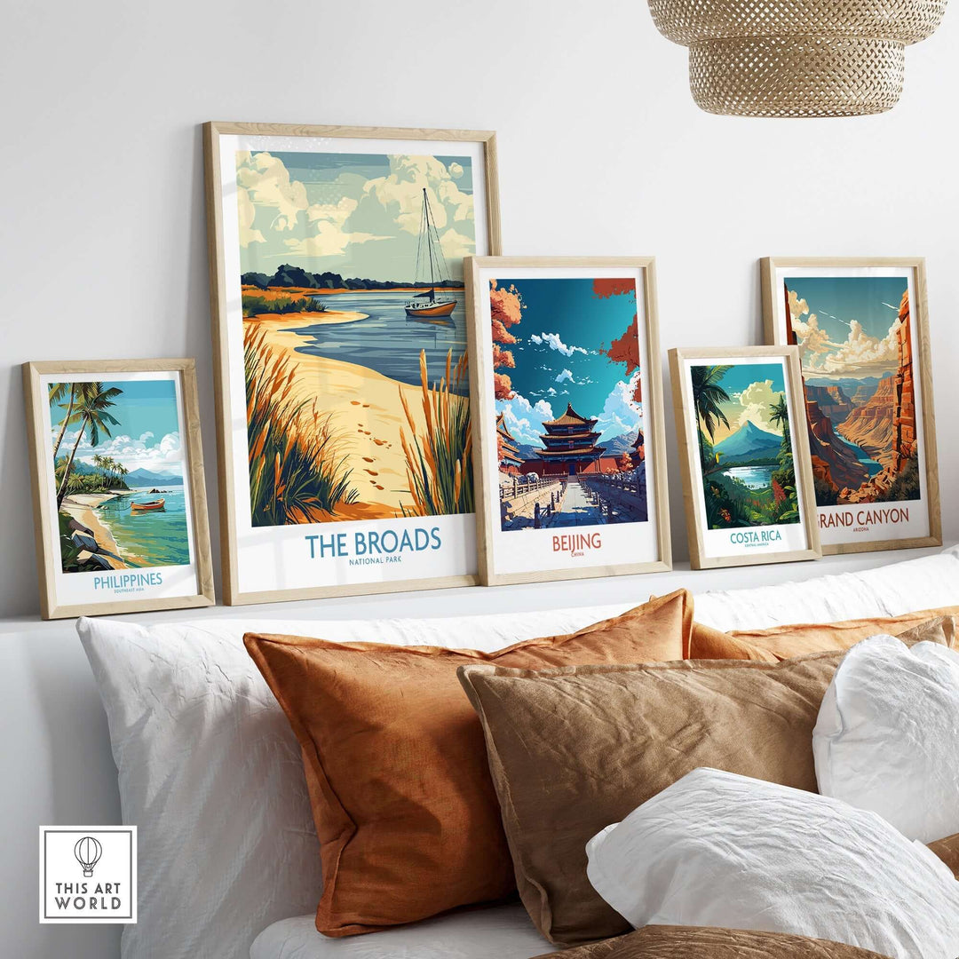 Vibrant art display featuring The Broads National Park poster among travel-themed posters in a cozy living space.