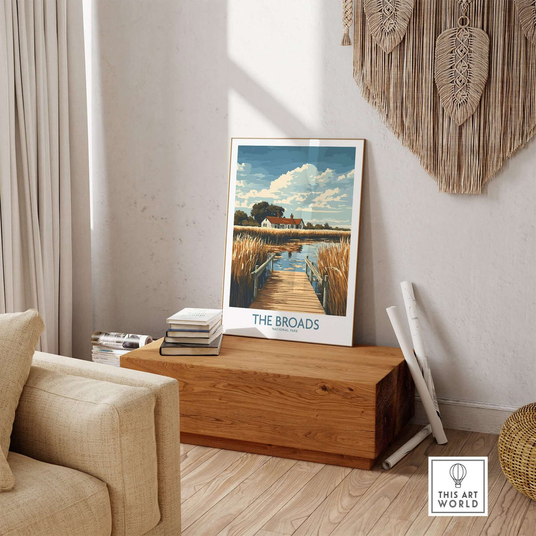 Broads National Park travel poster displayed in a cozy living room setting with wooden decor and soft furnishings.