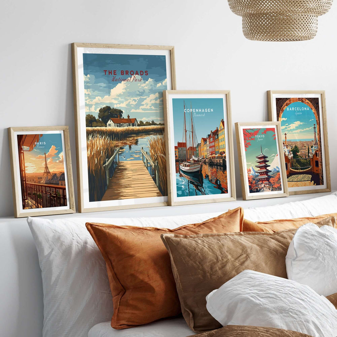 Framed travel prints of The Broads National Park, Copenhagen, and Barcelona displayed on a stylish living room wall.