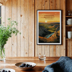Framed Theodore Roosevelt National Park art print on wood wall in rustic kitchen with fruit bowls