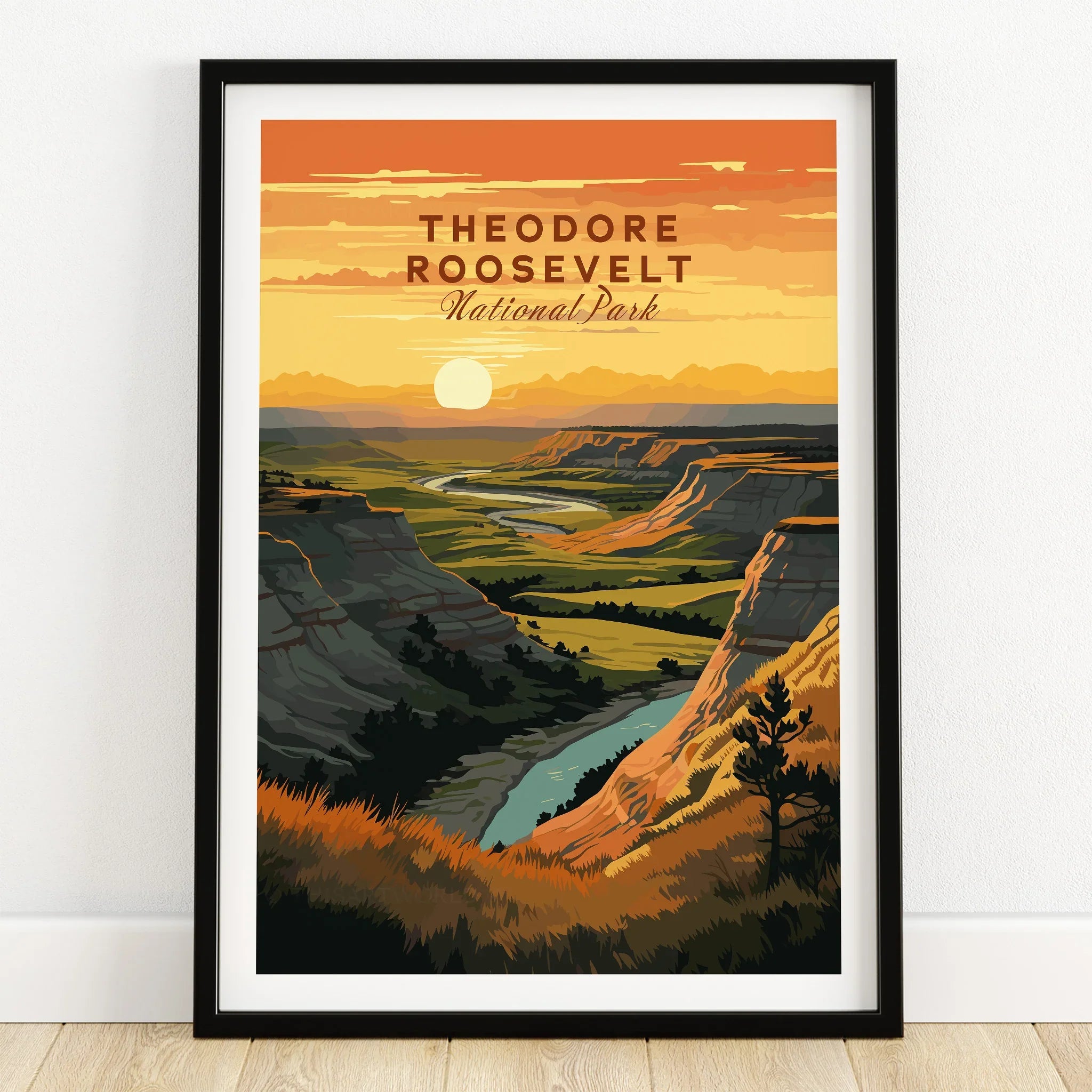 Theodore Roosevelt National Park art print in black frame on wooden floor, sunset landscape.