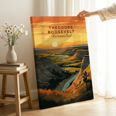 Hand holding Theodore Roosevelt National Park canvas print with sunset landscape art in room