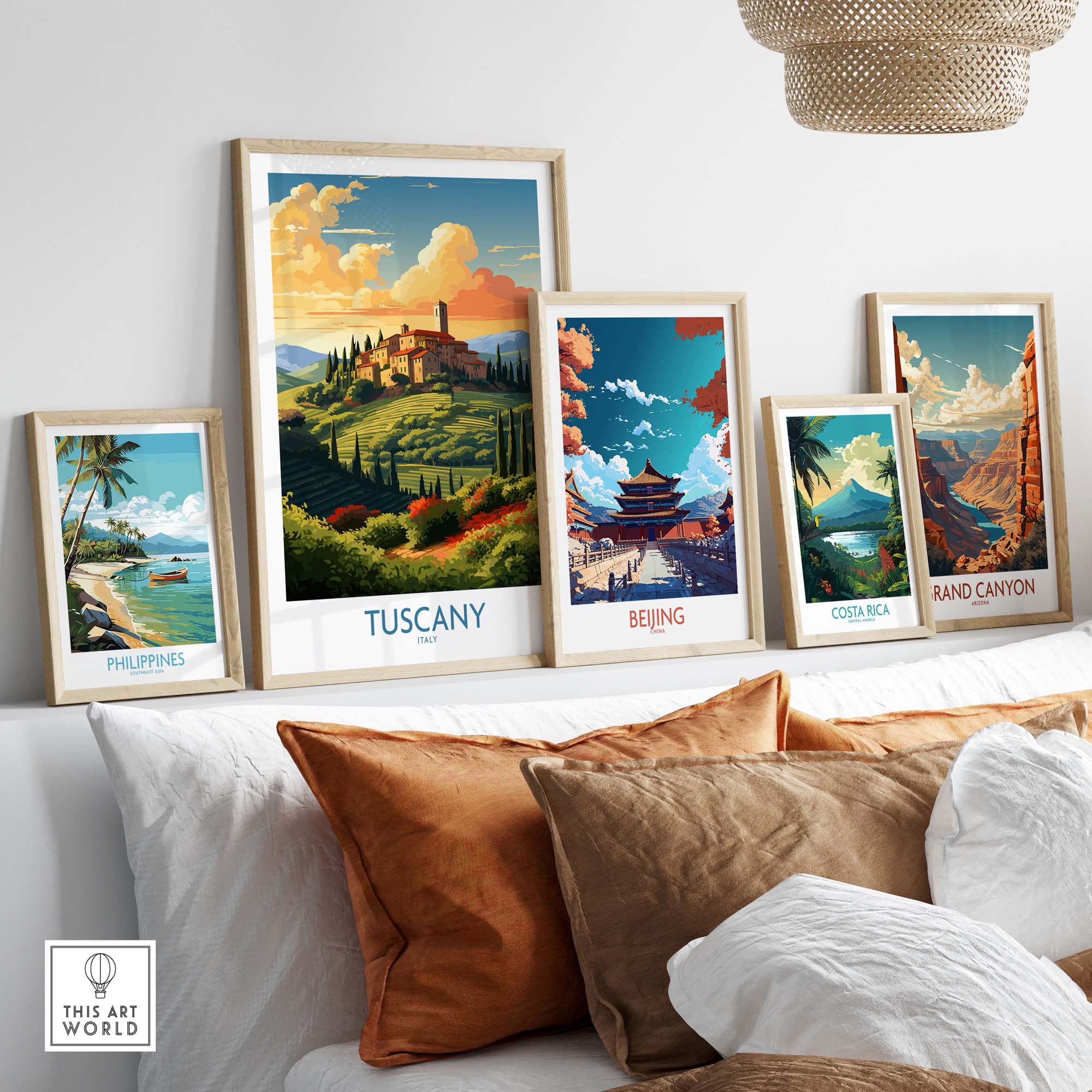 Framed travel posters of Tuscany, Beijing, Costa Rica, and the Grand Canyon displayed in a cozy living room setting.