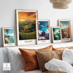 Tuscany Italy wall print surrounded by travel posters of Beijing, Costa Rica, and the Philippines on a stylish sofa.