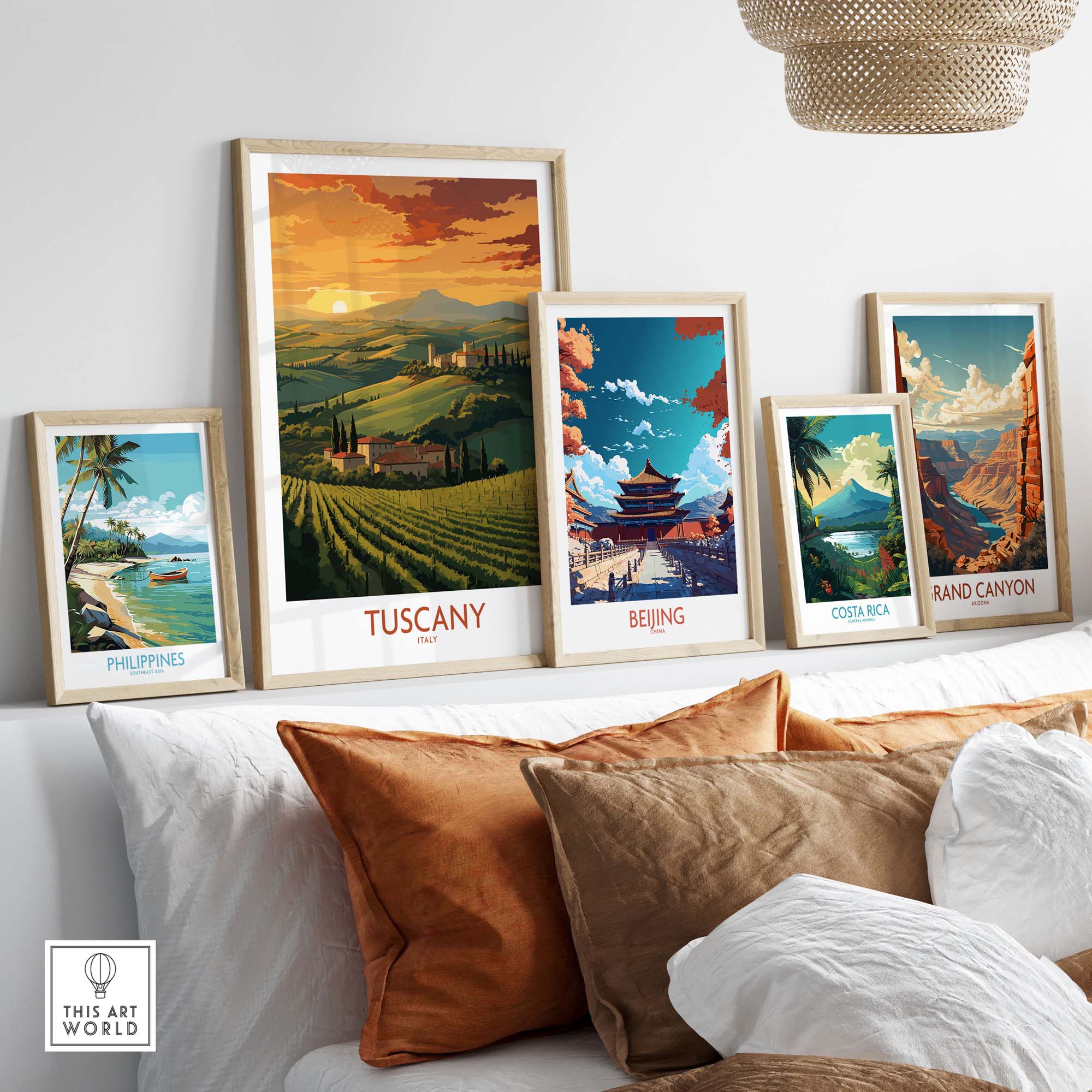 Tuscany Italy wall print surrounded by travel posters of Beijing, Costa Rica, and the Philippines on a stylish sofa.