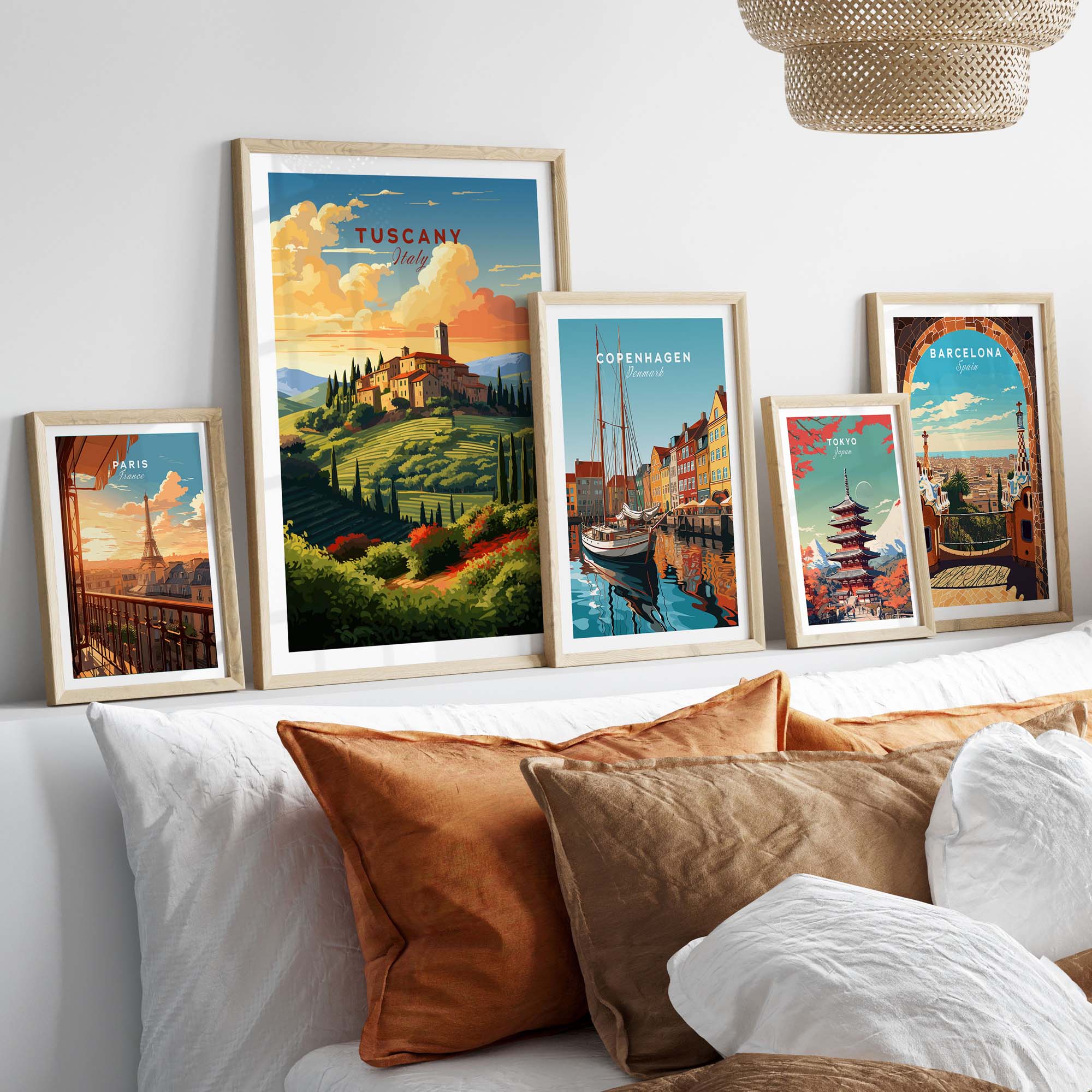 Cozy living room featuring framed Tuscany and travel prints on a gallery wall above decorative pillows.