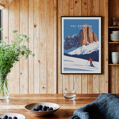 Val Gardena Print Italy ski poster featuring a skier against a mountain backdrop in a cozy interior setting.