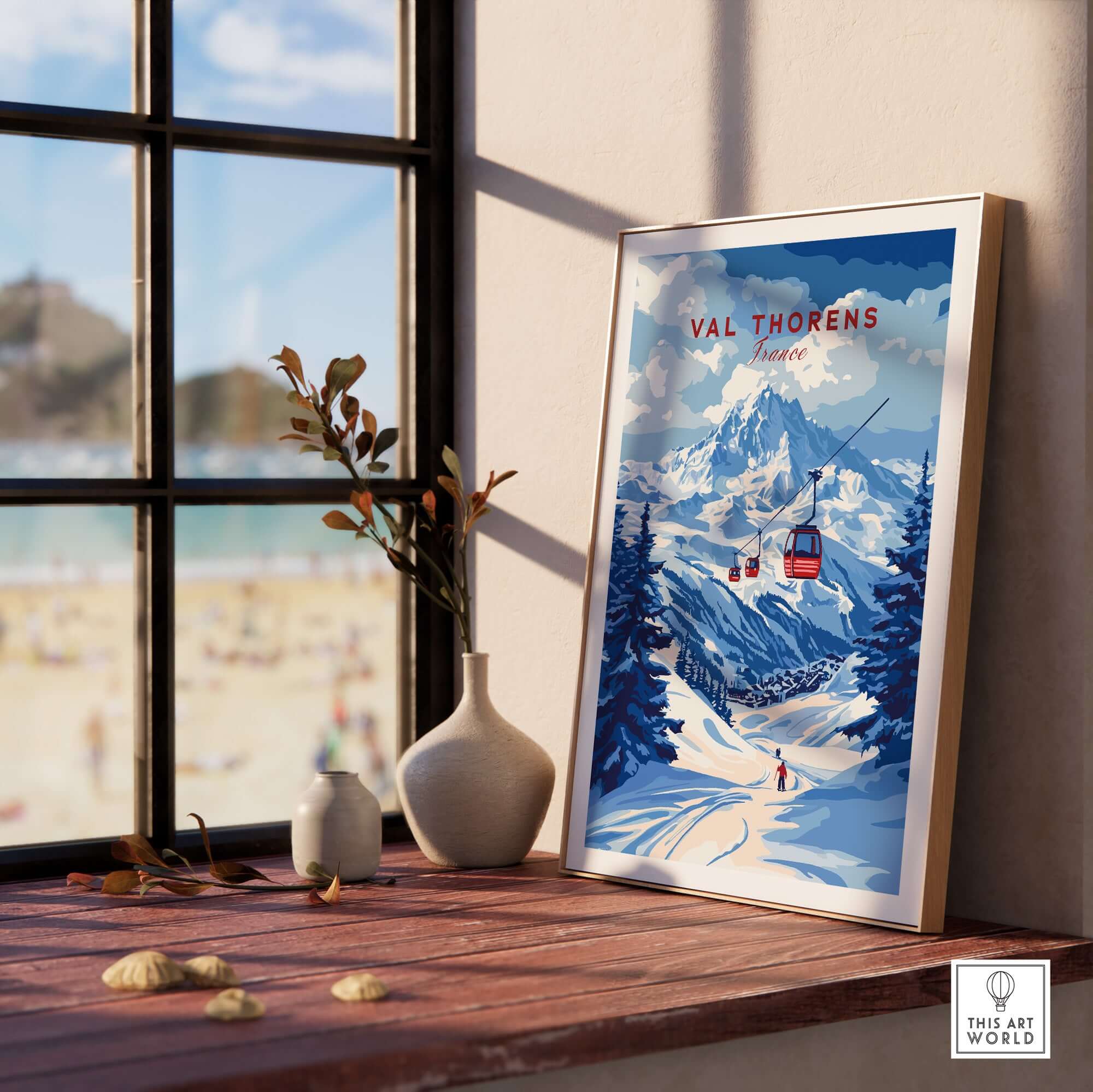 Val Thorens Poster France | Winter Sports Scene Print displayed on a table with a scenic winter backdrop.