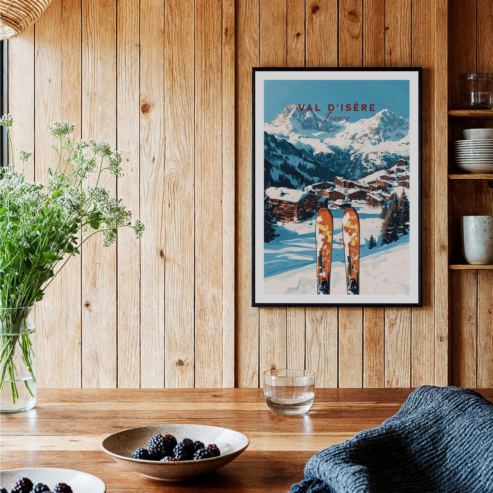 Val-d'Isère Ski Print displayed on a wooden wall, showcasing a picturesque winter landscape and skiing equipment.