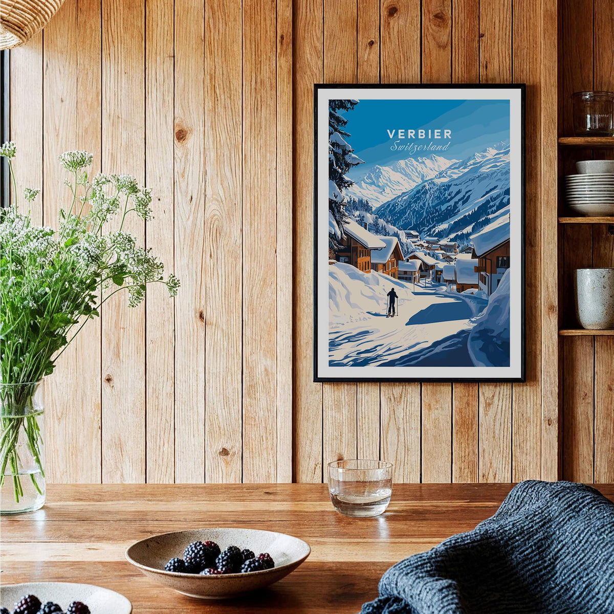 Verbier Ski Print Switzerland displayed on a wooden wall with a cozy interior and a view of snow-covered mountains.