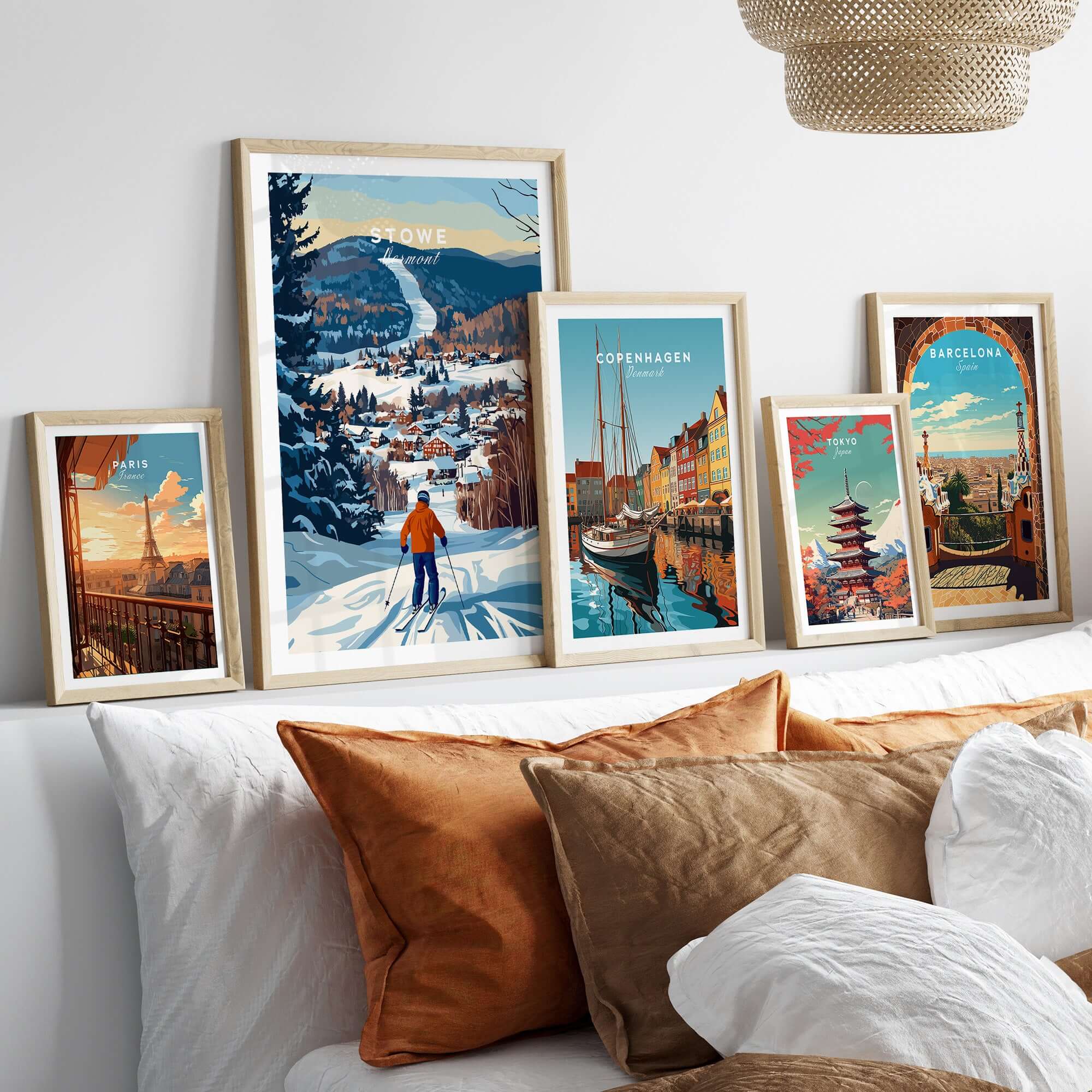 Vermont ski destination poster featuring Stowe Mountain, alongside vibrant travel art prints on a cozy sofa.