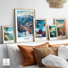 Framed travel art prints of Stowe, Beijing, Costa Rica, Grand Canyon, and the Philippines displayed on a cozy living room wall.