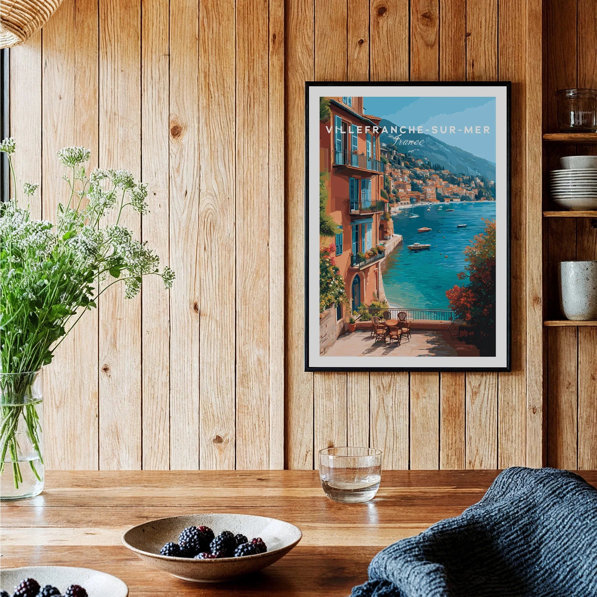 Villefranche-sur-Mer art print with coastal view in black frame, styled in rustic kitchen