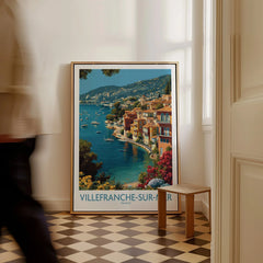 Villefranche-sur-Mer travel poster on floor in modern room with man walking past