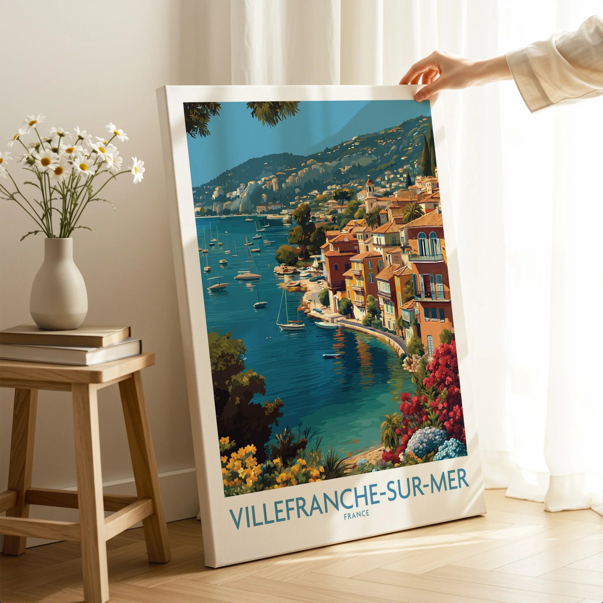 Villefranche-sur-Mer travel poster canvas print with colorful coastal artwork, hand holding in bright room