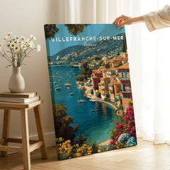 Villefranche-sur-Mer France travel poster canvas print with vibrant coastal art, hand holding edge in a bright room.