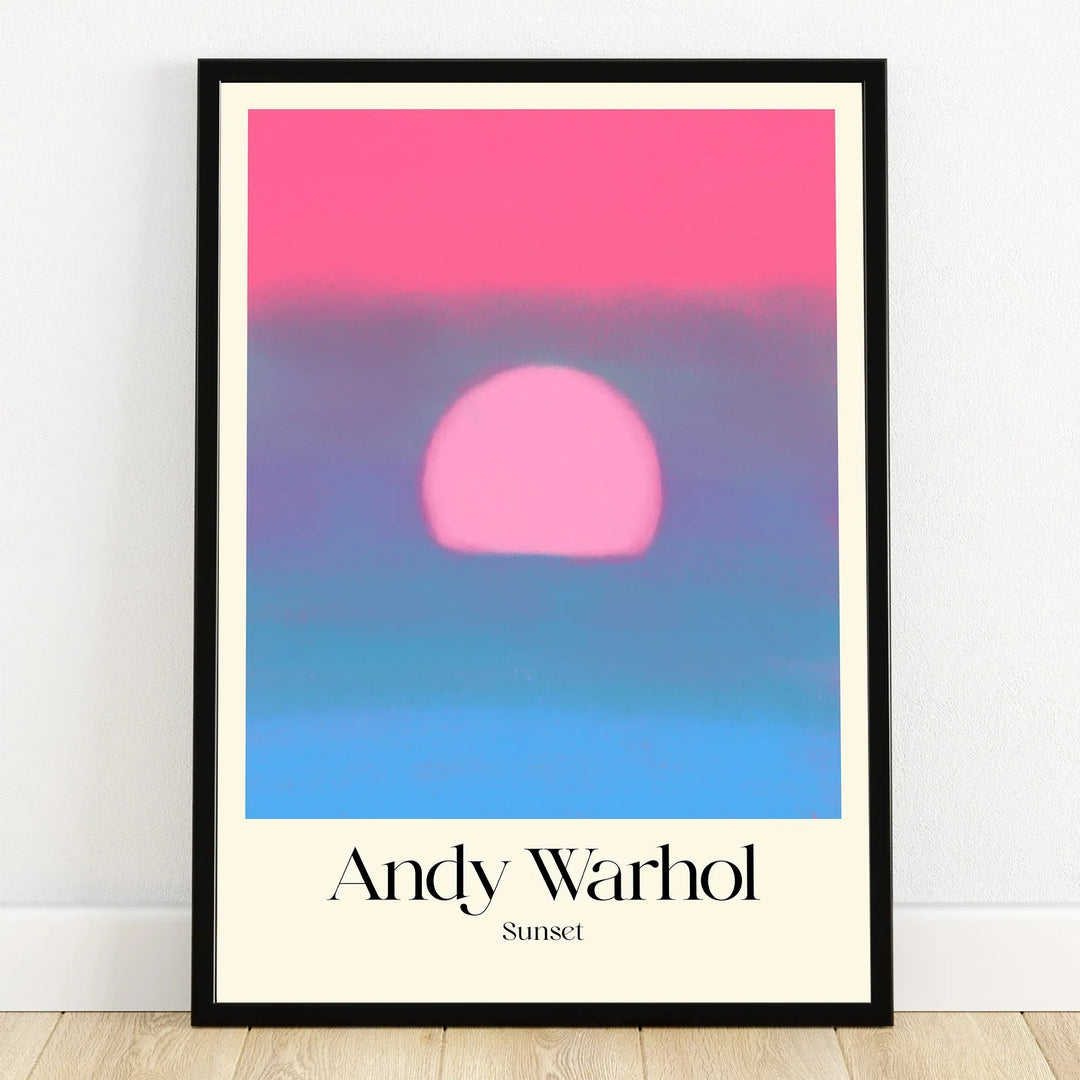 Framed Andy Warhol sunset print with bold pink sun and soft blue gradient wall art