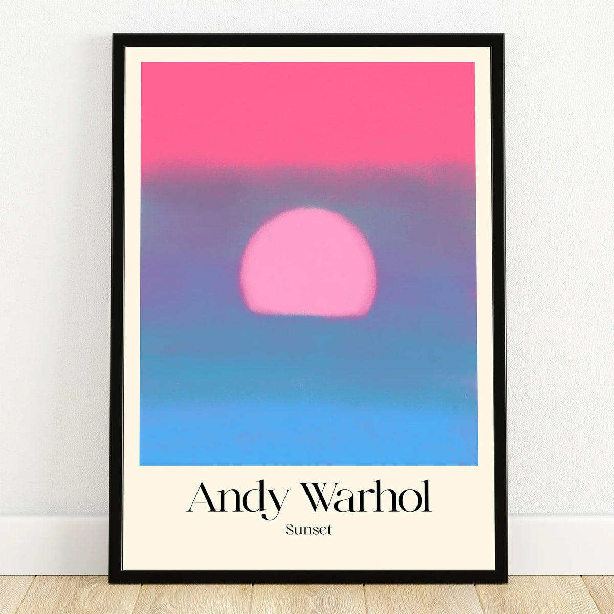 Framed Andy Warhol sunset print with bold pink sun and soft blue gradient wall art