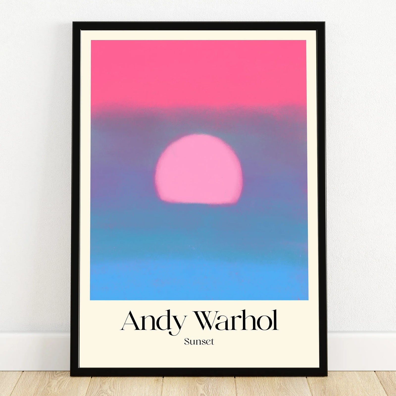 Framed Andy Warhol sunset print with bold pink sun and soft blue gradient wall art
