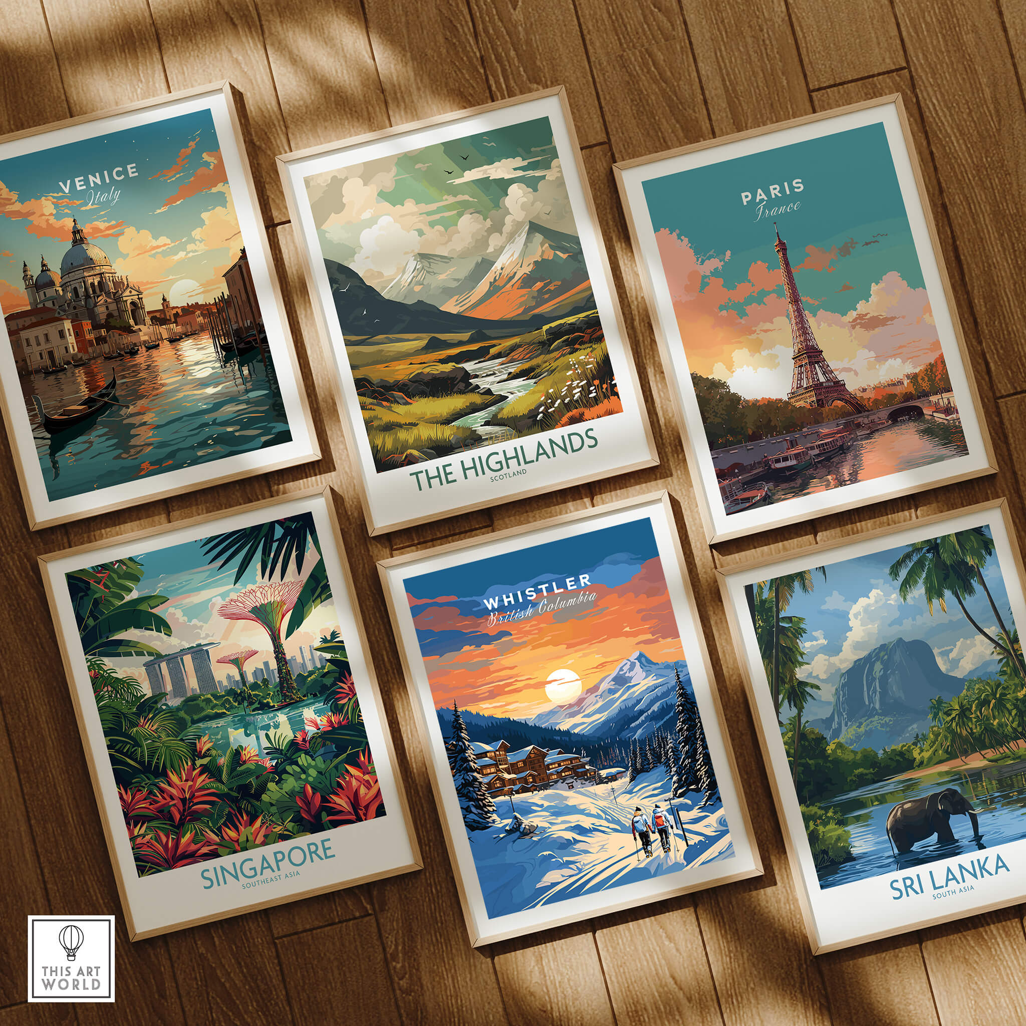 Six framed travel posters on wood floor, featuring landmarks from Venice, The Highlands, Paris, Singapore, Whistler, and Sri Lanka.