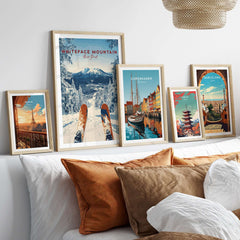 Framed Whiteface Mountain snow scene print with travel posters on a cozy living room wall.