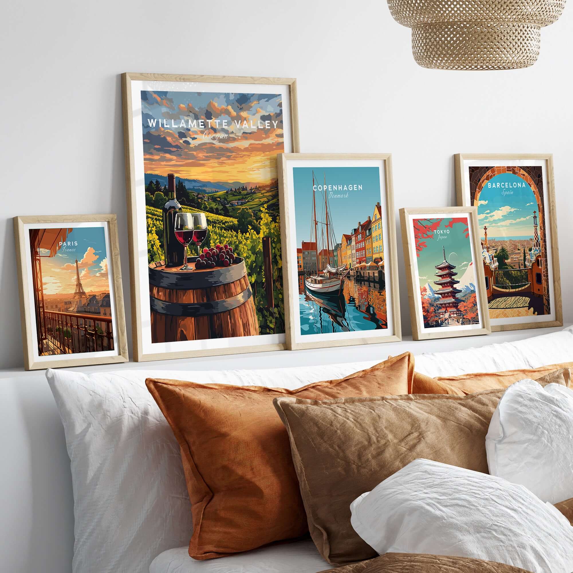 Willamette Valley Wall Art displayed among other vibrant travel-themed artworks on a stylish bed.