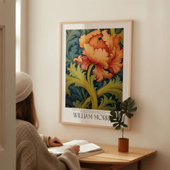 William Morris Orange Bloom Swirling Leaves Art Print - Botanical Poster displayed on a wall with a person reading nearby.