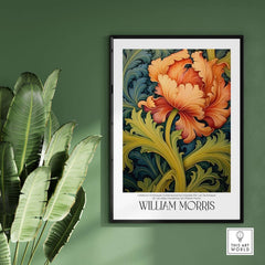 William Morris Orange Bloom Swirling Leaves Art Print - Botanical Poster on a green wall with a leafy plant.