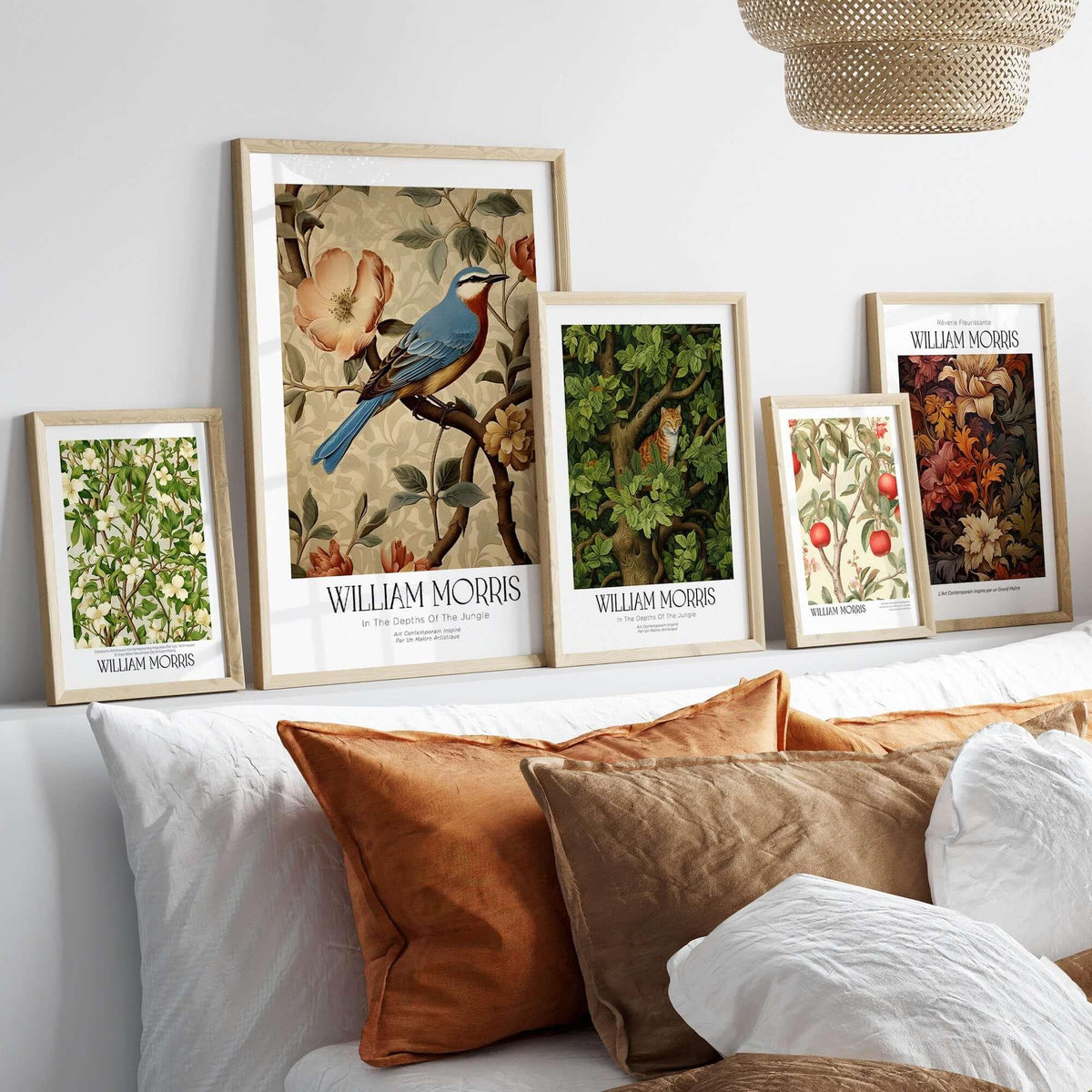 William Morris Prints - Blue Bird Floral Art Print - Botanical Poster displayed in elegant frames on a sofa.