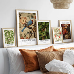 William Morris Prints - Blue Bird Floral Art Print - Botanical Poster displayed in elegant frames on a sofa.