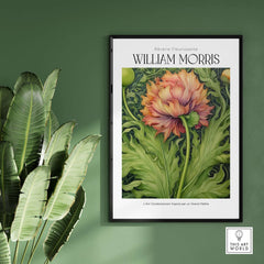 William Morris Prints - Large Floral Bloom Art Print - Botanical Poppy Poster framed on a green wall with plants.