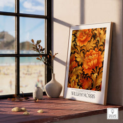 William Morris Prints - Orange Gold Floral Pattern Art Print - Dark Botanical Poster displayed on a wooden table by a window.